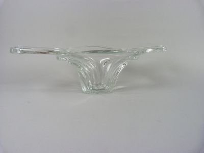 a clear glass bowl with a handle on a white surface