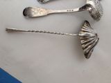 three spoons and a spoon rest on a table