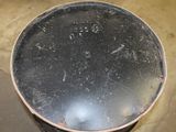 a metal pan sitting on top of a dirty floor