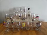 a lot of wine glasses sitting on a wooden table