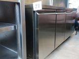 a stainless steel refrigerator in the middle of a room