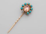 a gold, turquoise and pink stone broochle