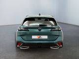 the rear end of a green car in a white room