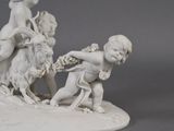 a figurine of a boy on a horse and a lion