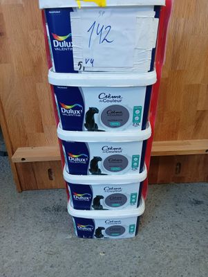 a stack of four boxes of toilet paper on the floor