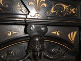 a black cabinet with a gold decoration on it
