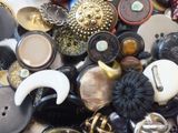 a pile of assorted buttons on a table