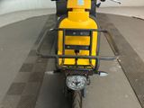 a yellow motorcycle parked in a parking lot