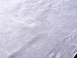 a white bed with a white comforter and a white pillow