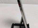 a cell phone that is on a stand on a bed