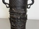 a black vase that is sitting on a table