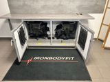 an iron bodyfit logo on the floor of a gym