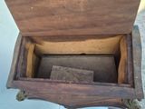 a wooden box with a piece of wood inside of it