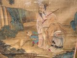 a picture of a cat that is sitting in front of a painting
