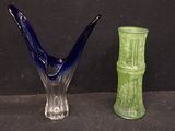 two glass vases sitting next to each other on a table