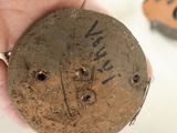 a person holding a piece of wood with writing on it