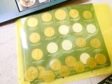 a lot of coins in a plastic bag next to a laptop