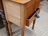 a small wooden table with a drawer underneath it