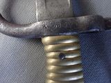 a close up of a sword with a metal handle