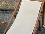 a chair that is sitting in the gravel next to a chair
