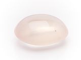 an oval pink quartz stone on a white background