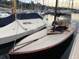 a boat that is docked in the water with other boats in the background