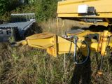 a yellow truck that is parked in the grass