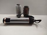 a hair dryer and a hair brush on a table
