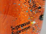 a bottle of orange liquid with sprinkles on it