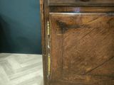 a wooden cabinet with a drawer on top of it