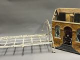 un lit miniature et une maison de poupées posés sur une table