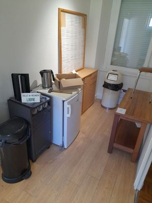 a small kitchen with a refrigerator, microwave, and a coffee maker