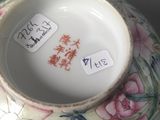 a vase with a floral design on it with a price tag on it