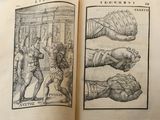 an open book with a drawing of a hand and a hand with a fist