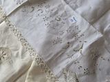 a close up of a bed with white sheets and a white pillow