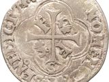 an old silver coin with a cross on it