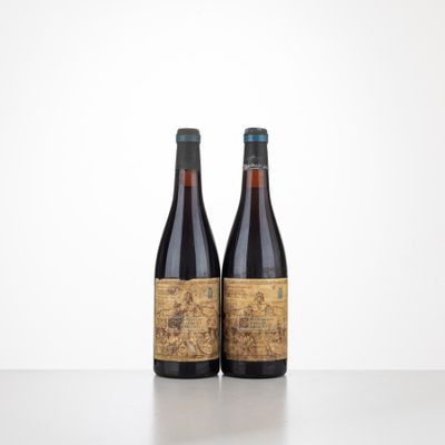 two bottles of wine sitting on top of a table next to each other