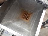 a metal box that has a drain in it
