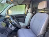 the interior of a van with two seats and a steering wheel