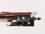 a close up of a violin bow with a bow rest