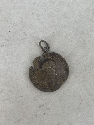a close up of a small coin on a white surface