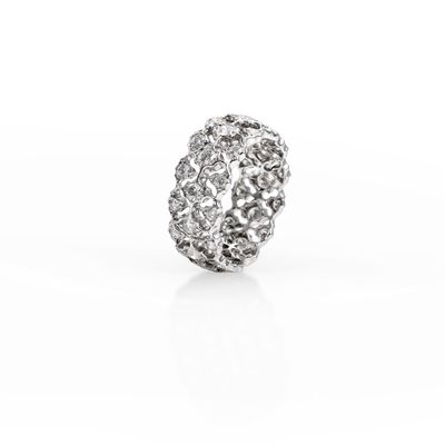 a close up of a diamond ring on a white surface