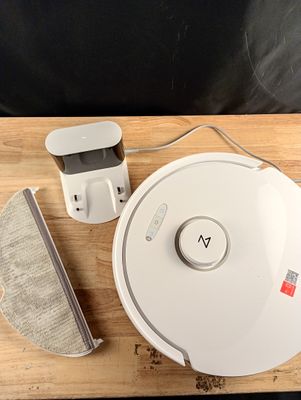 a white robot that is sitting on a wooden table