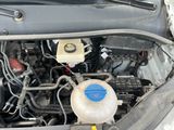 a car engine with the hood open and a blue cap on it