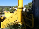 a yellow bulldozer that is parked next to a building