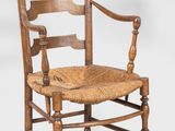 an old wooden chair with a woven seat on a white background