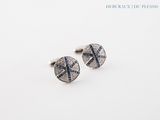 a pair of cufflinks with blue and white diamonds on them