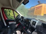 a view of a bulldozer through the windshield of a truck