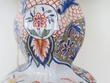 a decorative vase with a bird on it sitting on a table
