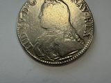 a close up of a coin on a white surface
